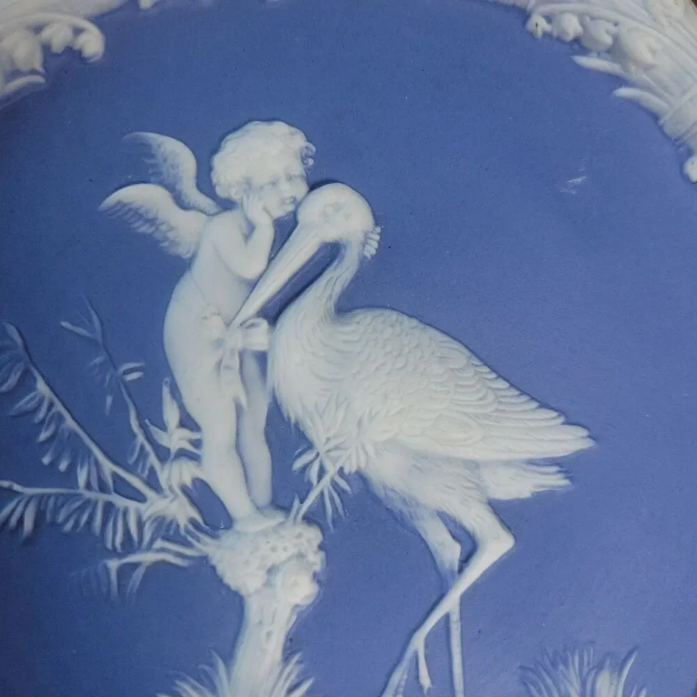 Schafer & Vater Blue & White Jasperware Plaque Featuring a Cherub & Stork Lily